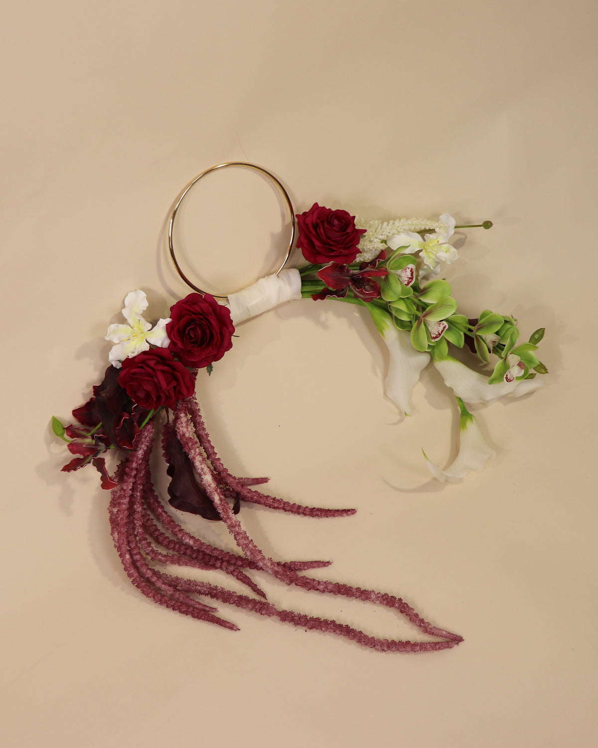 Burgundy Desire hoop bouquet featuring anthuriums, calla lilies and amaranth in rich burgundy tones with white and green accents.