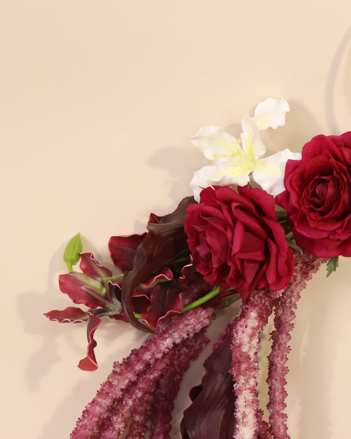 Burgundy Desire hoop bouquet featuring anthuriums, calla lilies and amaranth in rich burgundy tones with white and green accents.