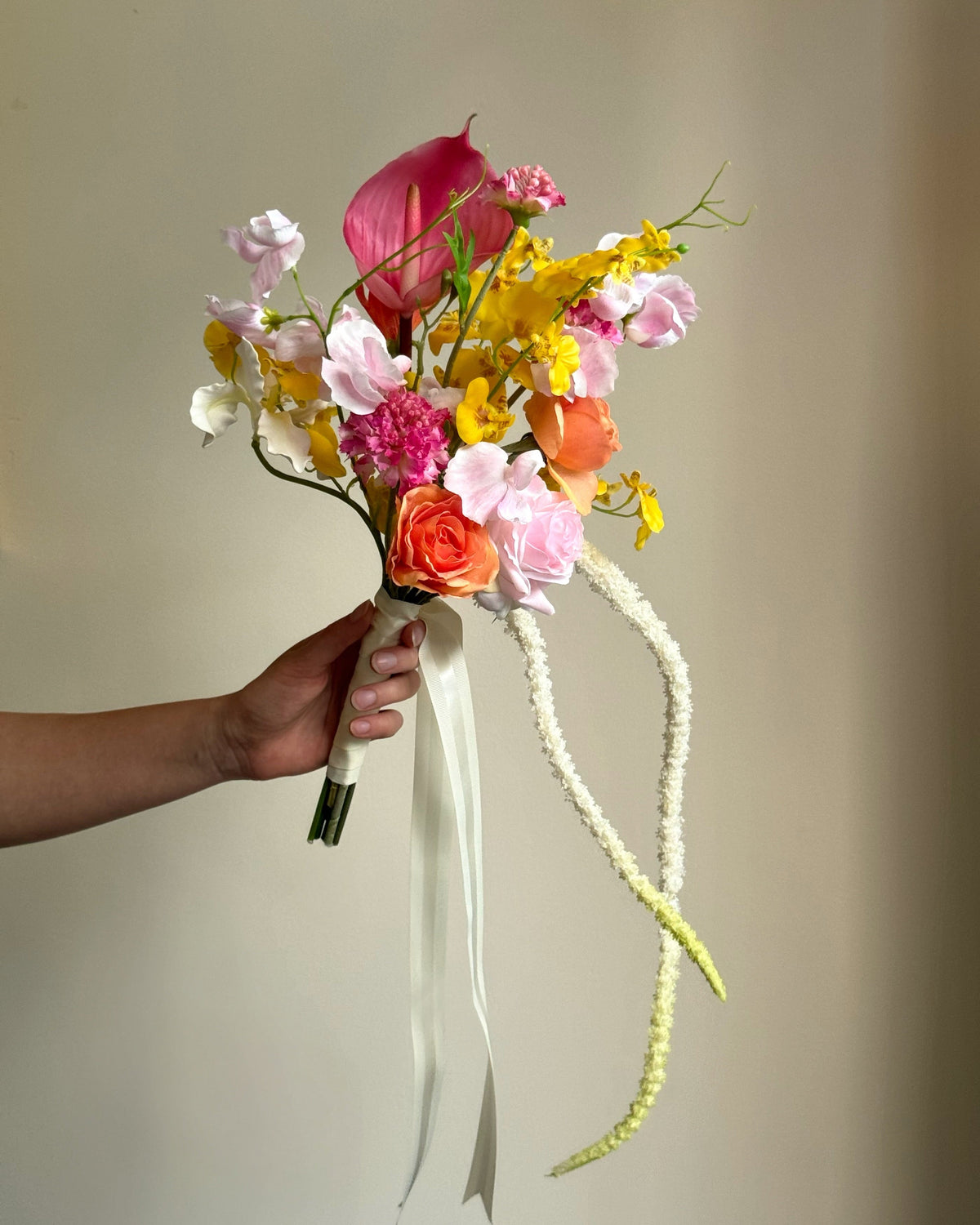 Tropical Punch bridal bouquet featuring bright, colourful real-touch flowers with satin ribbon-wrapped handle.