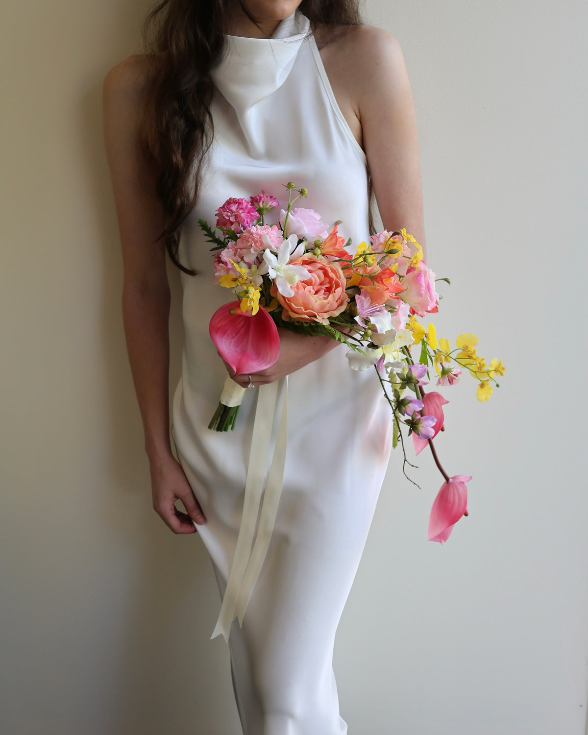 Tropical Punch cascading bouquet featuring bright, colourful real-touch flowers with satin ribbon-wrapped handle.