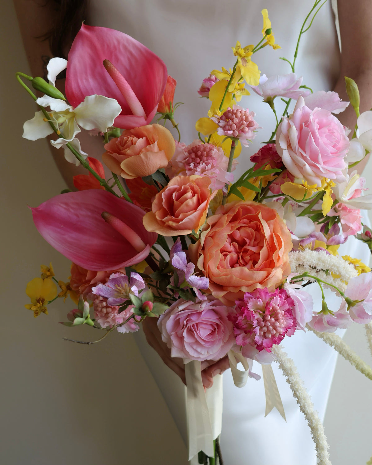 Tropical Punch bridal bouquet featuring bright, colourful real-touch flowers with satin ribbon-wrapped handle.