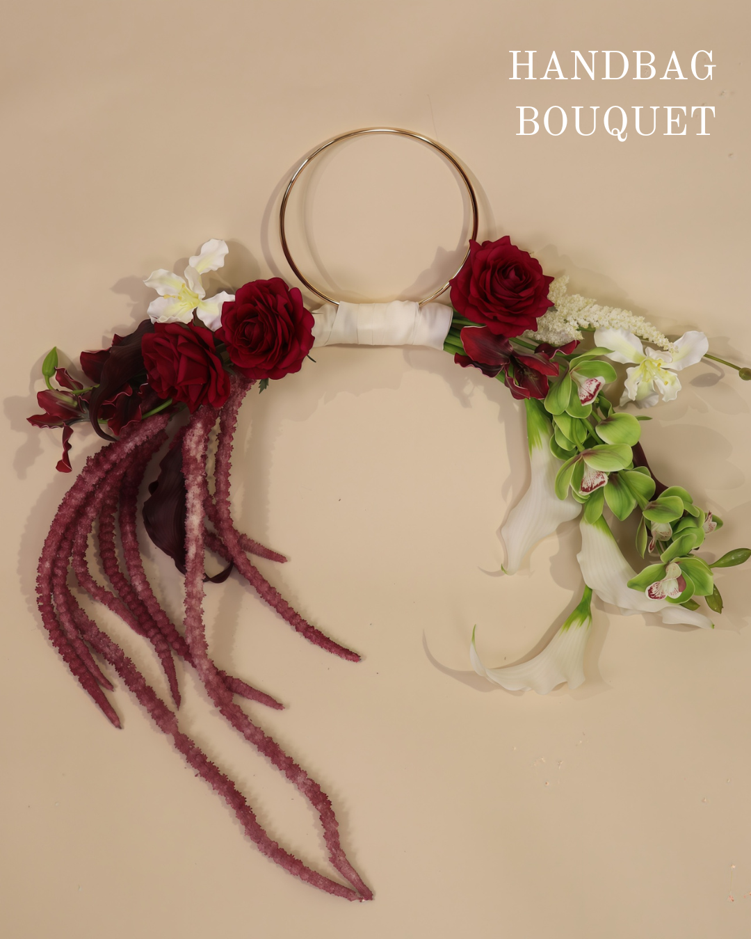 Burgundy Desire hoop bouquet featuring anthuriums, calla lilies and amaranth in rich burgundy tones with white and green accents.