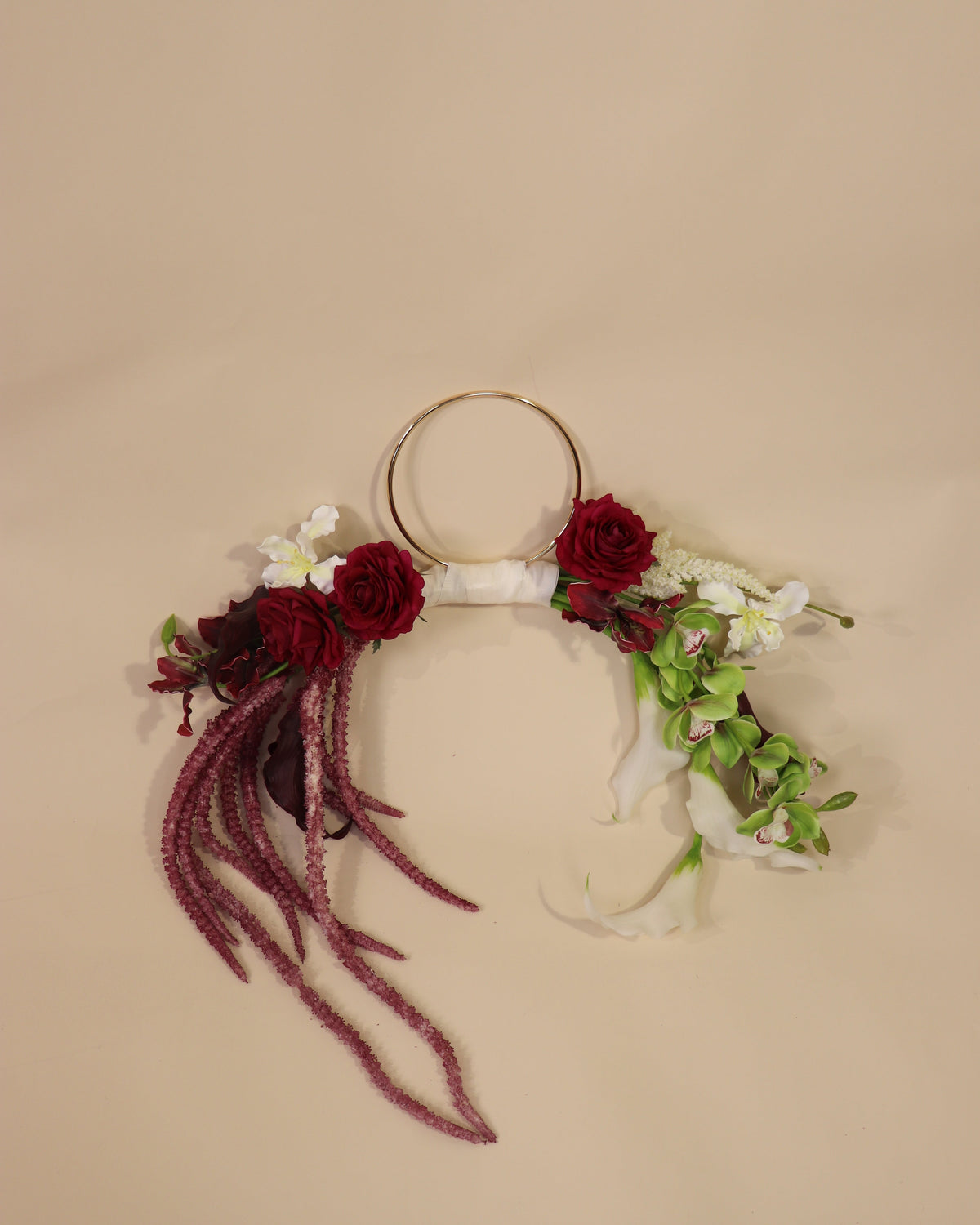 Burgundy Desire hoop bouquet featuring anthuriums, calla lilies and amaranth in rich burgundy tones with white and green accents.