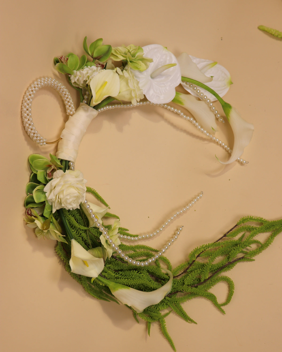 Greenstone Forest handbag bridal bouquet against a beige background