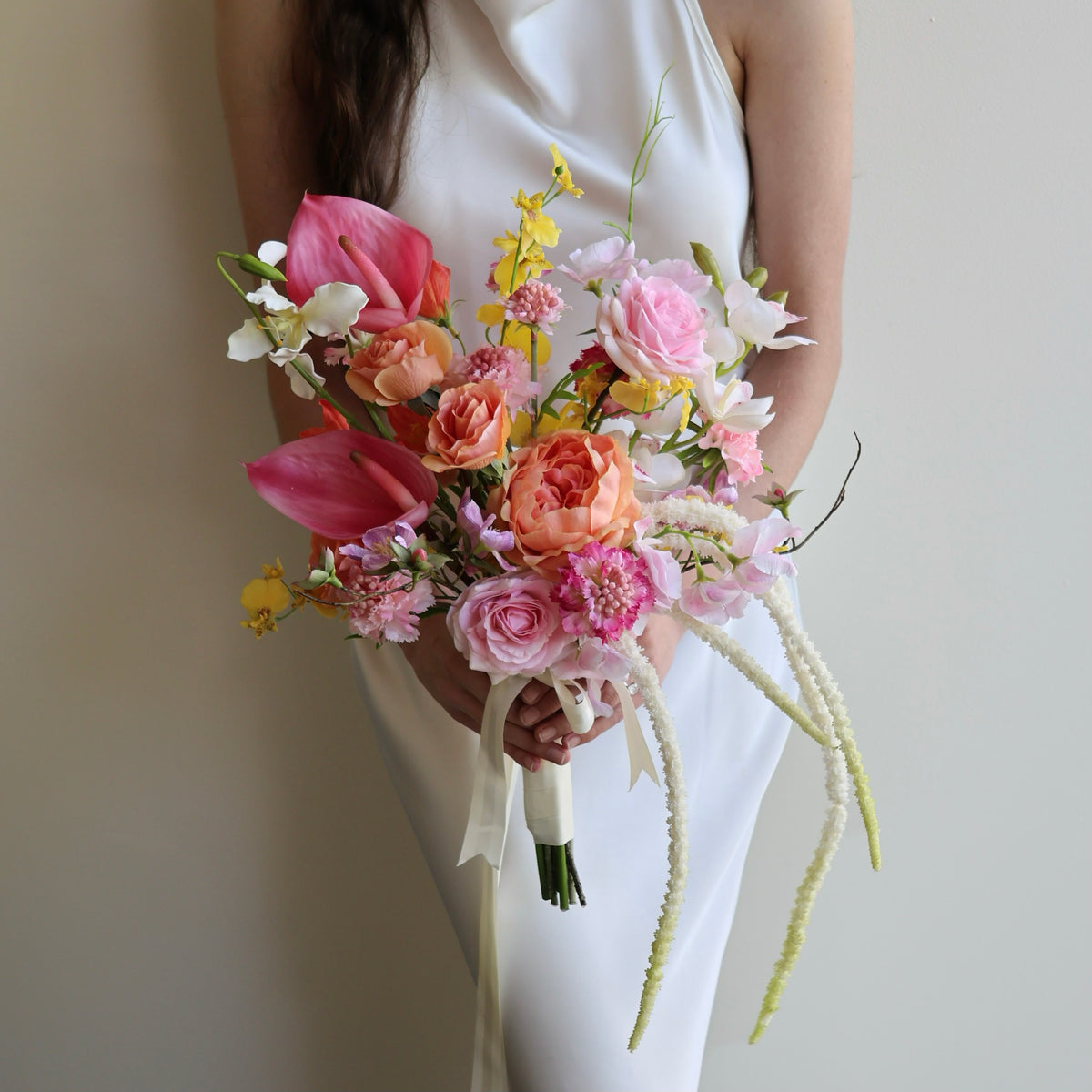 Tropical Punch bridal bouquet featuring bright, colourful real-touch flowers with satin ribbon-wrapped handle.