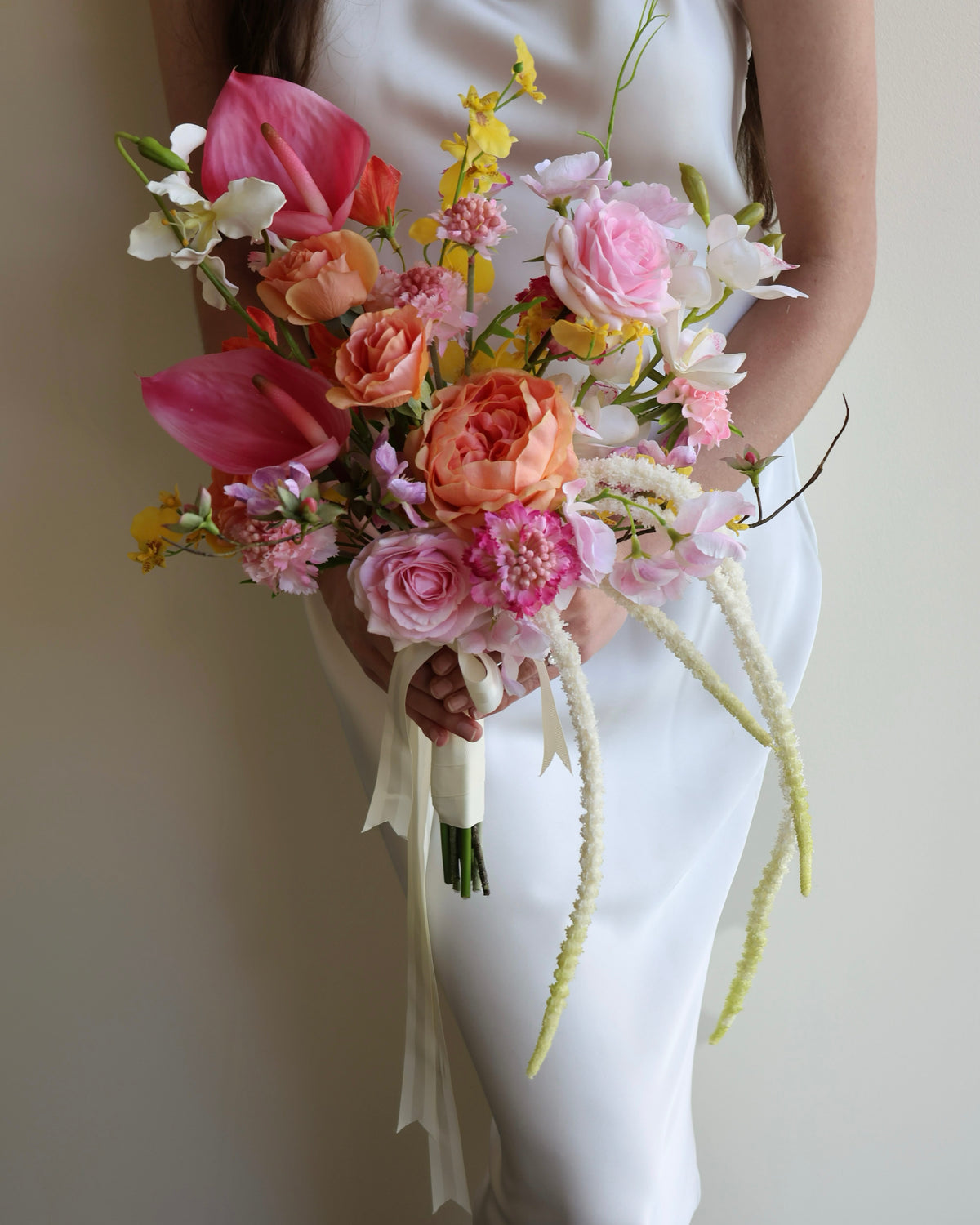 Tropical Punch bridal bouquet featuring bright, colourful real-touch flowers with satin ribbon-wrapped handle.