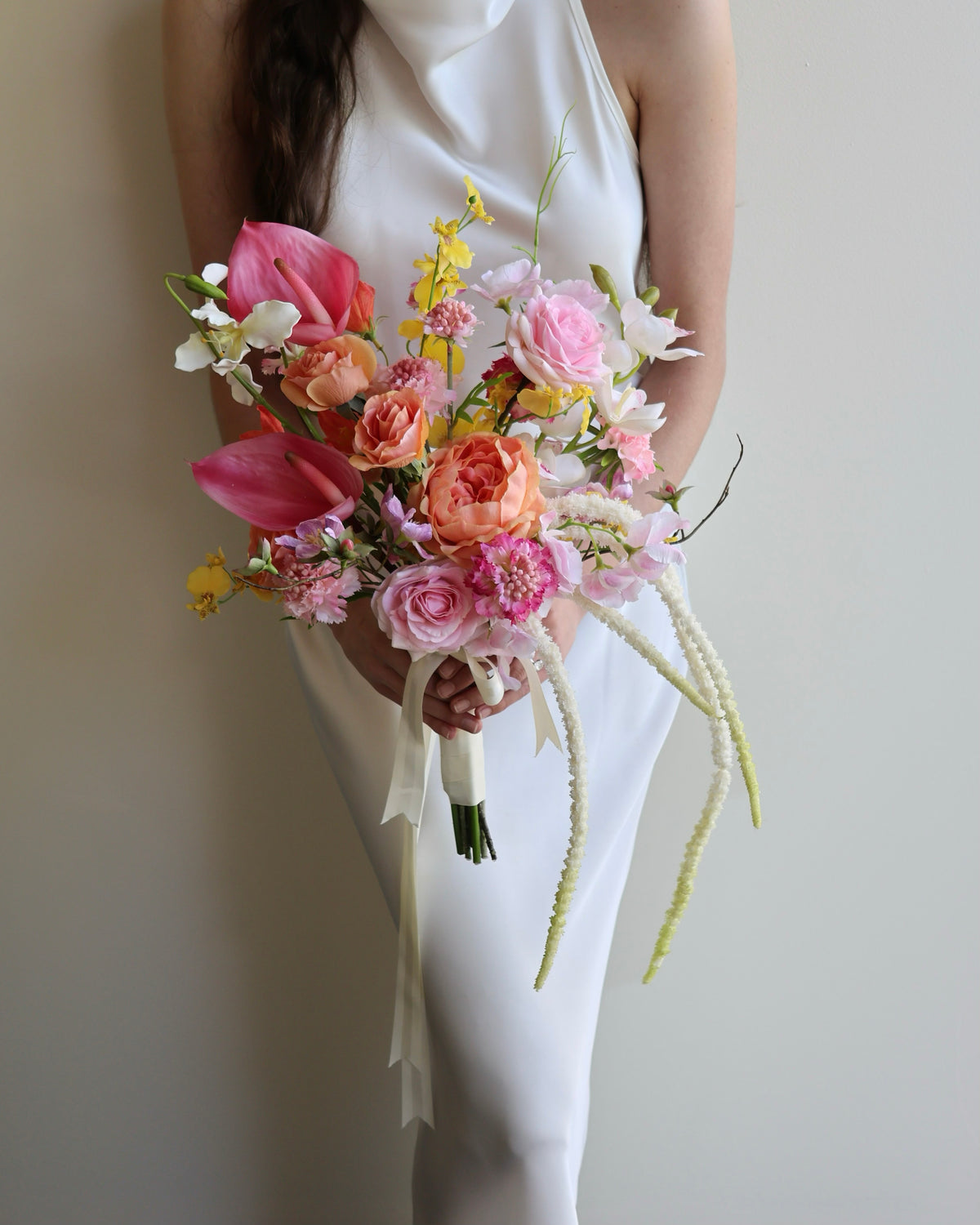 Tropical Punch bridal bouquet featuring bright, colourful real-touch flowers with satin ribbon-wrapped handle.