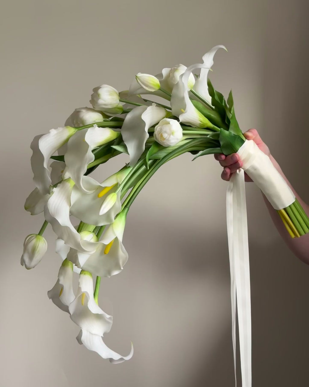 Cascading bridal bouquet with tulips and calla lilies